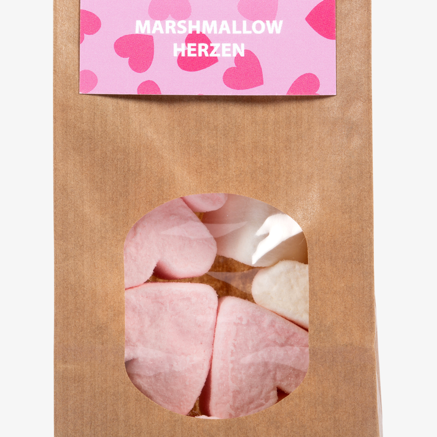 Detailansicht köstliche Marshmallow-Herzen in brauner Papiertüte mit Sichtfenster, individuelle Headerkarte
